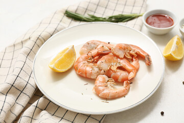 Plate with tasty boiled shrimps, lemon and rosemary on white background