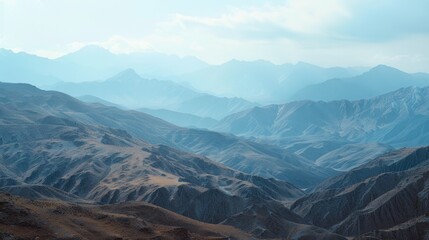 Fototapeta premium Aerial view of mountain ranges from above, with clouds and landscape visible