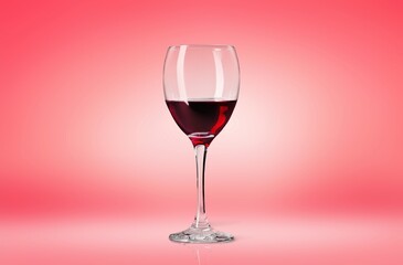 Red wine in glass on color background.