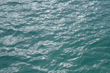 Abstract blue sea water. Background texture. Water in swimming pool or sea. Rippled water detail background. Blue sea surface.
