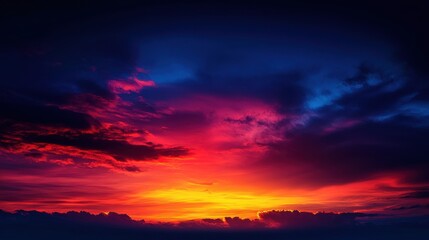 Fototapeta premium A vibrant sunset with a blend of red, orange, and blue hues illuminating the sky.