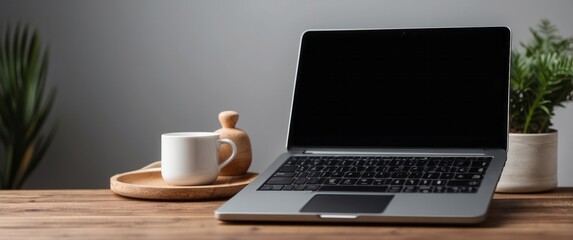 Fototapeta premium Laptop, Coffee Cup, and Plant on Wooden Table
