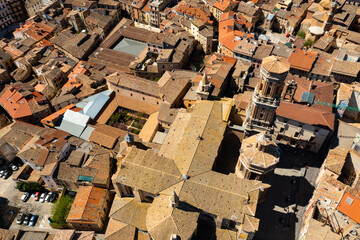 Scenic aerial view of medieval Roman Catholic Cathedral of Saint Mary surrounded by residential buildings with terracotta tiled roofs in historical center of Tudela on sunny spring day, Spain