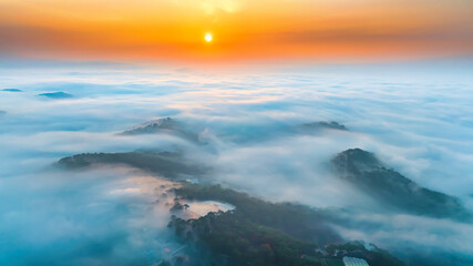 Obraz premium Aerial view of Xuan Tho suburbs near Da Lat city at morning with misty and sunrise sky. This place is considered most beautiful and peaceful place to watch sunrise in highlands of Vietnam