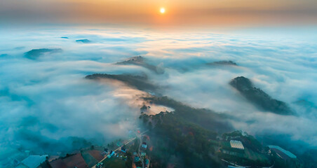 Obraz premium Aerial view of Xuan Tho suburbs near Da Lat city at morning with misty and sunrise sky. This place is considered most beautiful and peaceful place to watch sunrise in highlands of Vietnam
