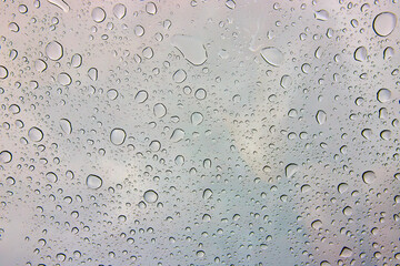 Water Droplets on Glass with Blurred Cloudy Sky Eye-Level View