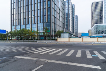 empty road with zebra crossing and skyscrapers in modern city