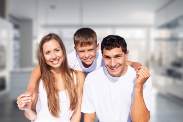 Happy young family having breakfast in kitchen