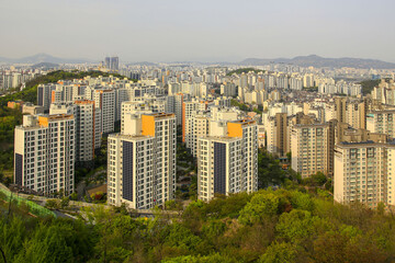 Geumho-dong, Seongdong-gu, Seoul, South Korea - April 21, 2022: High angle view of trees and apartments in spring against downtown Seoul in the background