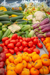 A  farmer's market stall table covered in summer vegetables