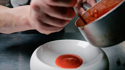 Chef Pouring Tomato Sauce For Plating 