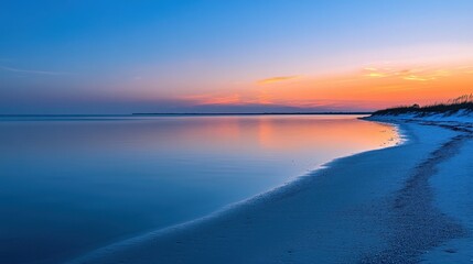 A serene beach at sunset, showcasing calm waters and a colorful sky.