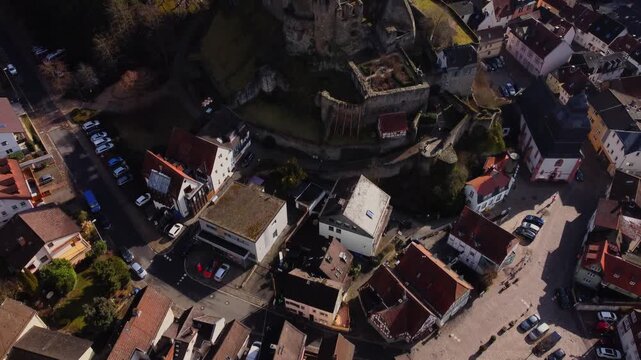 Drone footage of Eppstein Castle and medieval old town in Germany at sunrise. The serene morning light highlights historic architecture of castle and medieval town of Europe. Shots: Move In, Tilt 45