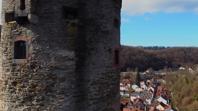 Drone footage of Eppstein Castle and medieval old town in Germany at sunrise. The serene morning light highlights historic architecture of castle and medieval town of Europe. Shots: Slider Reveal