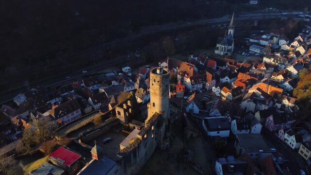 Drone footage of Eppstein Castle and medieval old town in Germany at sunrise. The serene morning light highlights historic architecture of castle and medieval town of Europe. Shots: Parallax Slow