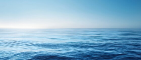 Fototapeta premium A tranquil blue ocean scene with soft waves and a clear sky
