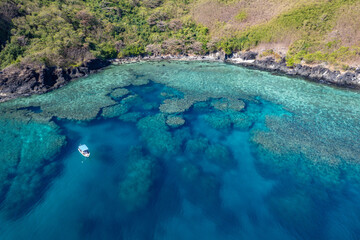 Aerial view above Scuba dive and snorkeling site coral reef beside tropical Island in Fiji	