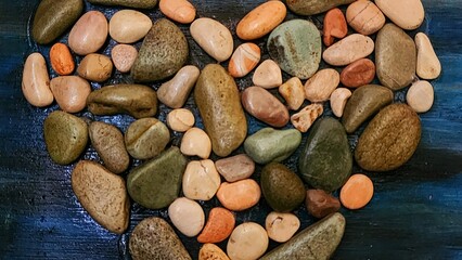 a heart made of stones on a blue background