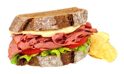 Pastrami and salad sandwich in sliced German style crusty sourdough rye bread with mayonnaise isolated on a white, background