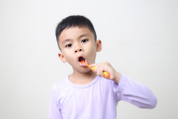 child Asia kid boy brushing teeth isolated on white backgroud.