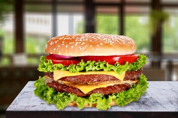 Tasty hot cheese beef burger on desk