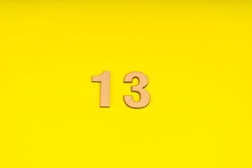 Number Thirteen in leather on yellow background