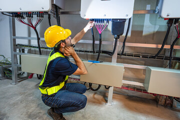 Service Engineer use tablet working inspection installation inverter solar cell. Technician...