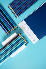 Obraz premium Notebook with math formulas paper and gradient blue pencil on the podium, Back to school, education concept
