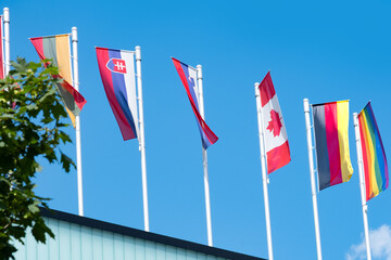 EU national flags flutter in wind, government Buildings, Space Agency, Parliament, Council Europe, Court of Justice, European Commission