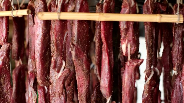 Fan dried biltong South African traditional venison meat jerky rotating on wheel