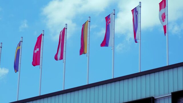 EU national flags flutter in wind, government Buildings, Space Agency, Parliament, Council Europe, Court of Justice, European Commission