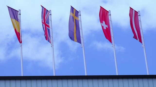 national flags Europe and other countries on satin flutter in wind in blue sky, European Space Agency, state symbols, concept of international cooperation, global business