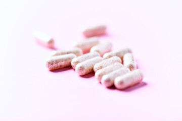 Collagen capsules. Bright paper background. Soft focus. Close up. Copy space.