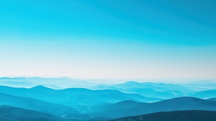 Obraz premium Blue Mountains and Sky Wallpaper. A serene landscape wallpaper with a distant mountain range bathed in blue hues under a clear sky.