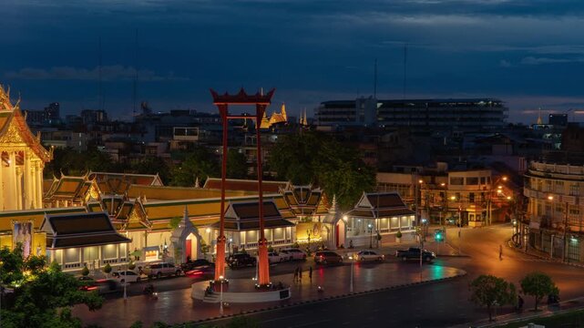 Time lapse of The Giant Swing or Sao Ching Cha monument with Wat Suthat temple at night in old town, Bangkok City, Thailand. Landmark tourist attraction. Thai architecture with travel trip concept.