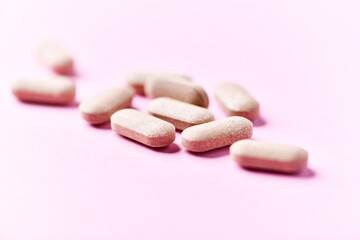Ashwagandha (Withania somnifera) tablets. Concept for a healthy dietary supplementation. Bright paper background. Close up. Copy space