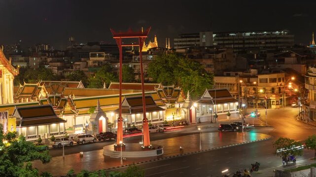 Time lapse of The Giant Swing or Sao Ching Cha monument with Wat Suthat temple at night in old town, Bangkok City, Thailand. Landmark tourist attraction. Thai architecture with travel trip concept.