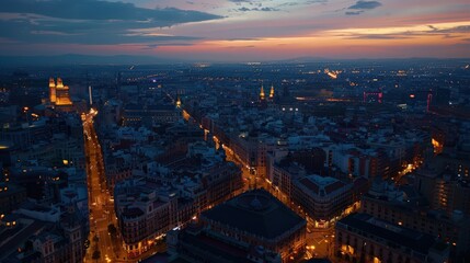 Fototapeta premium Visualize Madrid at twilight from above, with city lights illuminating the streets and landmarks against the dusky sky