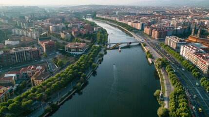 Visualize Madrid's riverfront and bridges, such as the Manzanares River and its crossings, in a sweeping aerial photograph.