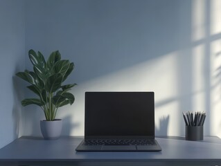 Fototapeta premium Minimalist Home Office Desk with Laptop, Plant, and Pencils in a Gray Room with Sunlight Streaming in.