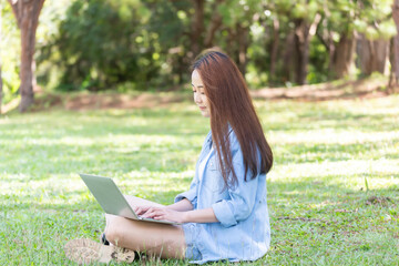 Women with mobile phones and tablets in the beautiful backyard.