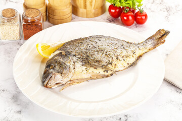 Baked Dorado fish served lemon