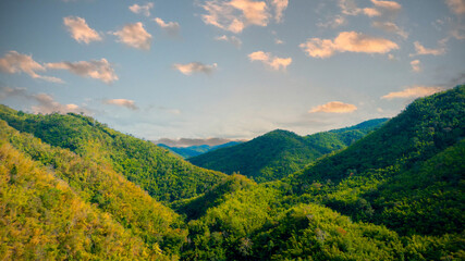 Fototapeta premium Panorama view with wonderful springtime landscape in mountains. grassy field and rolling hills. rural scenery