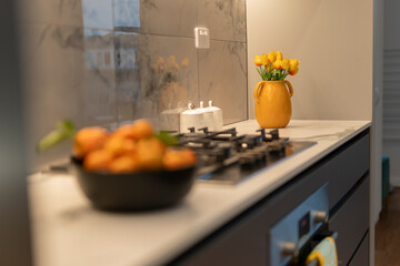 kitchen countertop with gas hob and fresh citrus fruit 