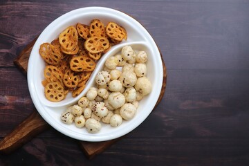 Crispy lotus stem chips and roasted makhana, perfectly spiced and golden brown, offer a delightful crunch and unique flavor. Ideal for healthy snacking or as a gourmet appetizer. kurkuri Kamal kakdi. 