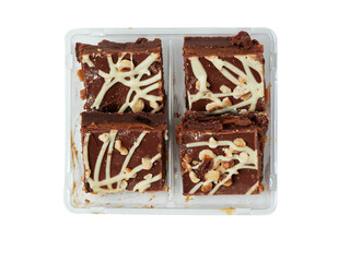 A tray of chocolate covered cake with nuts on white background. The tray is divided into four sections. The chocolate is drizzled over the nuts, giving them a delicious and appetizing appearance