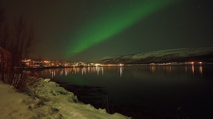 A beautiful green and red aurora dancing over the hills
