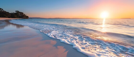 Naklejka premium The sun sets over the watery beach, a wave advances toward the shore, and trees lie distant