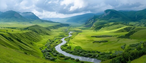 Obraz premium A valley with a river flowing, mountains in the background distantly, and clouds scattering the sky