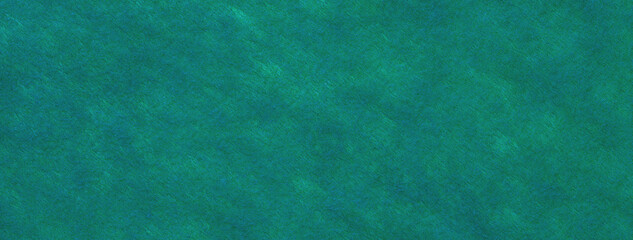 Texture of dark green and cyan felt fabric background with spots, macro. Structure of teal woolen textile